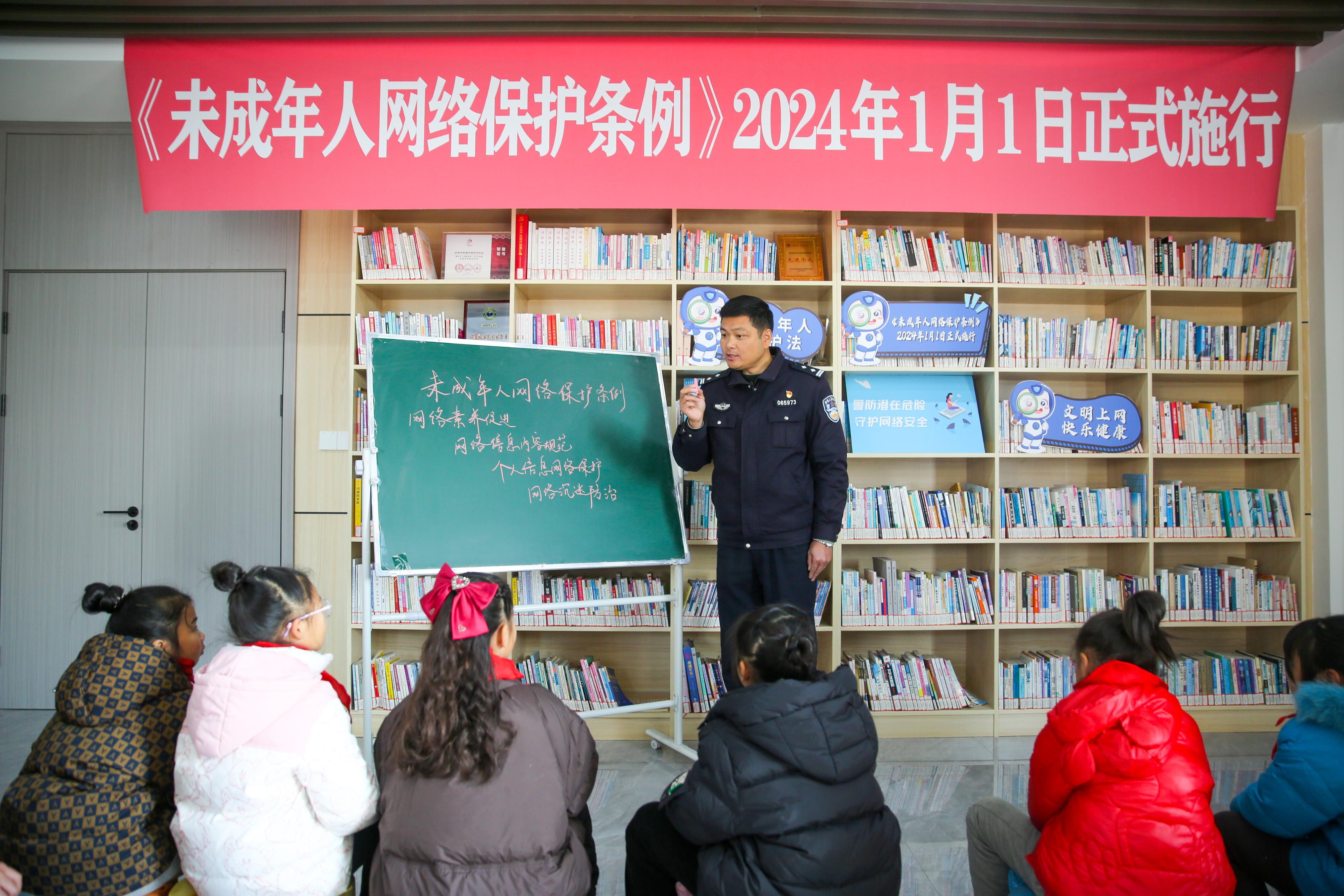 2024年1月1日，在江苏南通如皋市城南街道新华社区农家书屋内，网络普法志愿者向学生讲解《未成年网络安全保护条例》相关内容。.jpg
